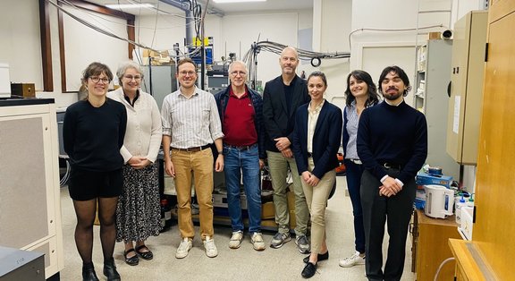 Group of people standing in a laboratory setting