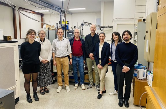 Group of people standing in a laboratory setting