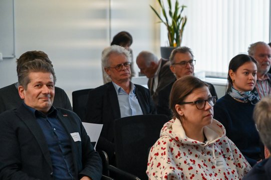 Participants at a seminar in a modern conference room