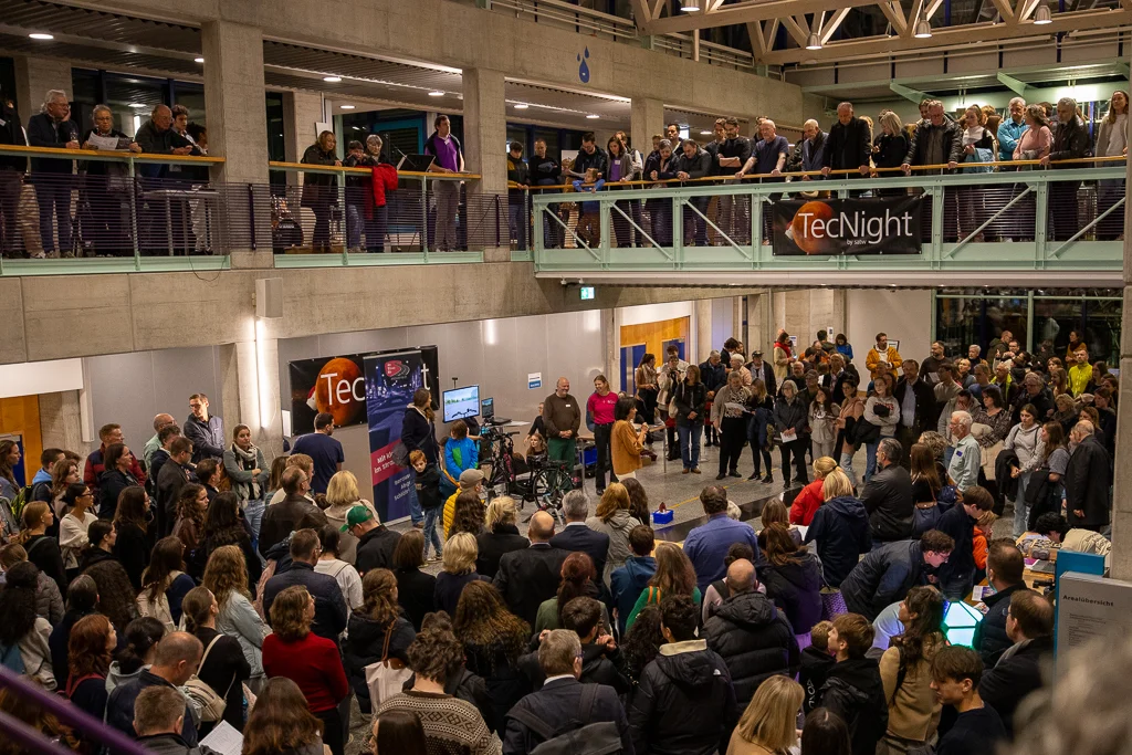 Visitors gather in an auditorium on two floors at TecNight