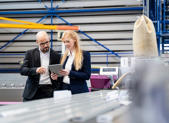 Colleagues reviewing data on a tablet in an industrial environment